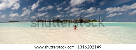 Woman is relaxing in a Maldivian lagoon