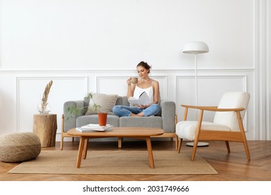 Woman relaxing in a minimal home - Shutterstock ID 2031749666