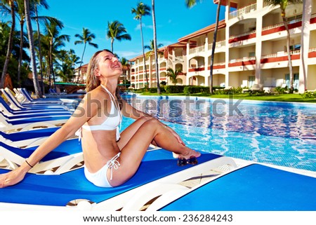 Woman relaxing near the pool. Vacation at caribbean resort