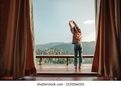 Woman relaxing on balcony which can see the mountain view and morning fog, Happy traveller stay in hotel. - Powered by Shutterstock