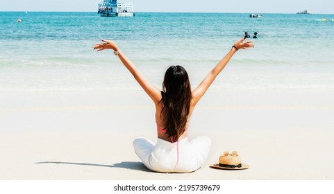 Woman Relaxing On The Beach With Cool Breeze