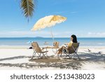 A woman is relaxing on the beach sea space area. Beautiful tropical beach and Inflatable boat with blue sky and white clouds in sunny day