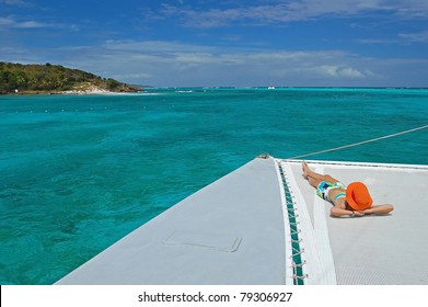 Woman Relaxing On Catamaran Near Tobago Cays On Caribbean Sea