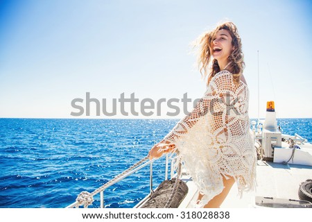 woman relaxing on a cruise boat wearing knitted dress
