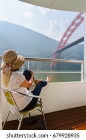 Woman Relaxing  On Cruise Ship, Yangtze River China, View Of Qingchuan Bridge