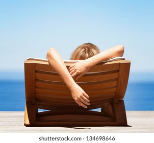 woman relaxing on deck chair