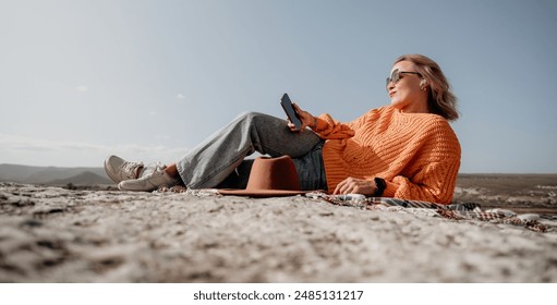 Woman Relaxing on a Mountaintop with a View - Powered by Shutterstock