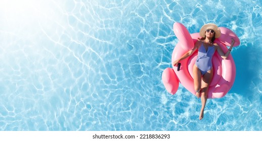 Woman relaxing on pink flamingo inflatable ring. Sunny pool vacation. Flat lay with copy space - Powered by Shutterstock