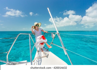 Woman relaxing on saiboat in middle of the sea