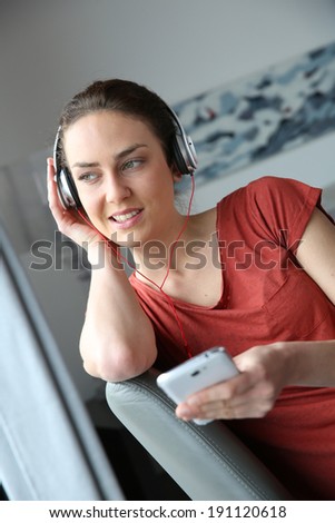 Similar – Happy woman listening to music wearing headphones