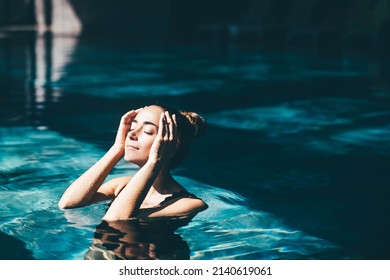 Woman relaxing in the swimming pool. - Powered by Shutterstock