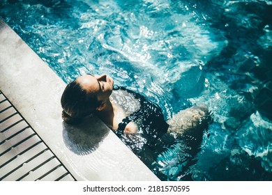 Woman relaxing in the swimming pool. - Powered by Shutterstock