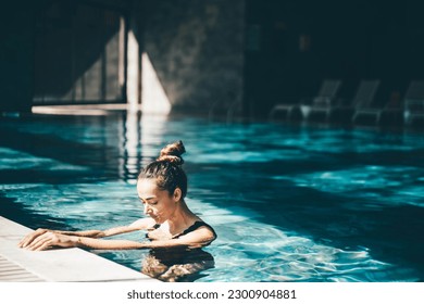 Woman relaxing in the swimming pool. - Powered by Shutterstock