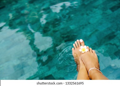 Woman Relaxing In Swimming Pool In Bali Luxury Resort. Foot Spa And Pedicure Lifestyle Photo, Topv View.