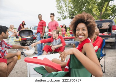 Woman relaxing at tailgate barbecue in field