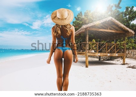 Woman relaxing under the sun at the crystalline sea