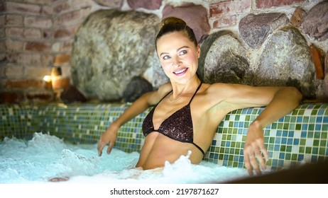 Woman Relaxing In A Whirlpool Bath Tube