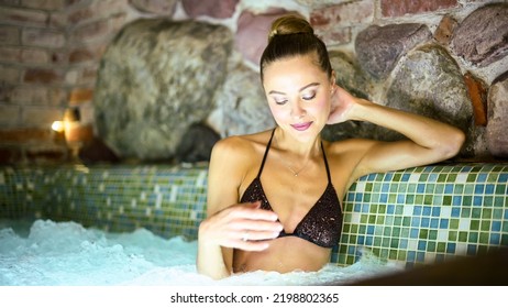 Woman Relaxing In A Whirlpool Bath Tube