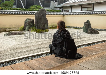 Woman is relaxing in a zen garden in Japan