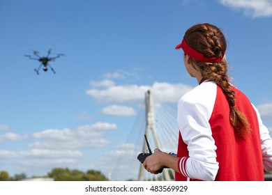 Woman With Remote Control And Flying Surveillance Drone