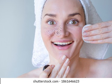 
Woman removes blackheads with cleansing lotion