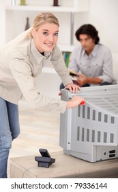 Woman Removing The Back Of A Tv Set