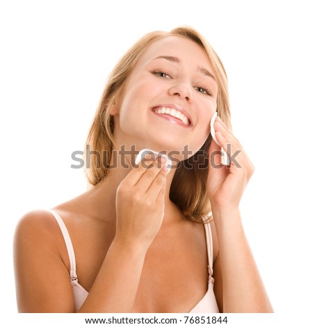 Woman removing makeup with cleansing pad