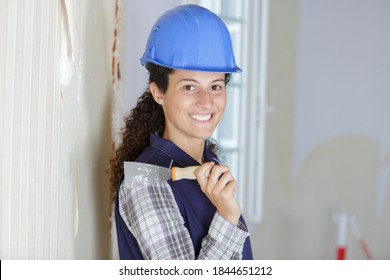 A Woman Removing Wall Paper