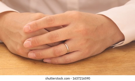 Woman Removing Wedding Ring From Finger