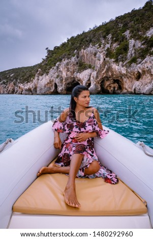 woman in rental boat cruising the Orosei coast  Sardinia, Cala Gonone Italy