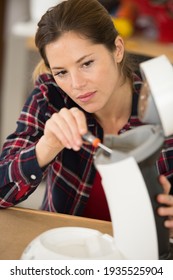 Woman Repairing Broken Coffee Machine