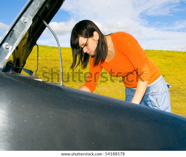 woman repairing the\
car