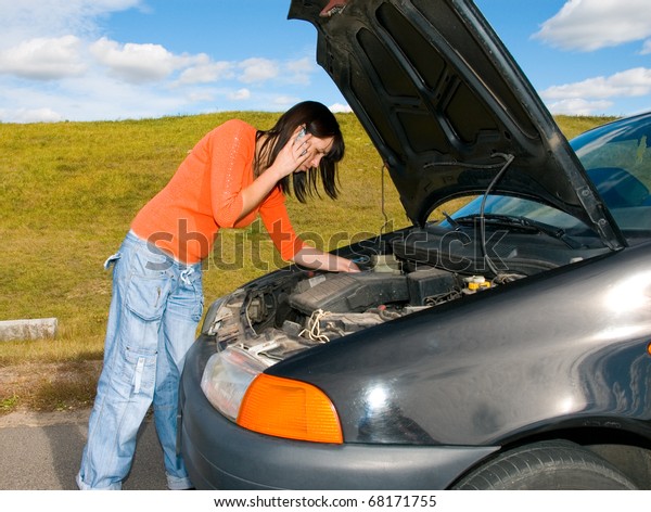 woman repairing the\
car