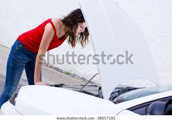 woman repairing car failure\
outside