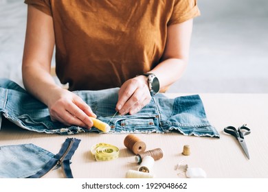 Woman Repairs Sews Reuses Fabric From Old Denim Clothes Economical Reuse