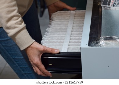 Woman Is Replacing Furnace Filter At Home