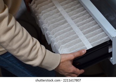 Woman Is Replacing Furnace Filter At Home