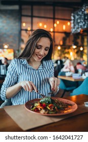 Woman In Restaurant Eating Keto Food