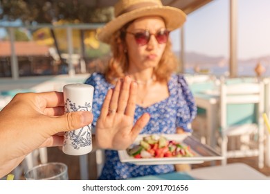 Woman In A Restaurant Refuses The Offered Salt And Pepper Shaker With A Gesture Of Her Hand. Diet For Gout And High Cardiovascular Blood Pressure