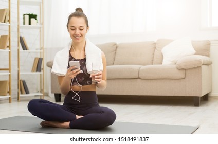 Woman Resting After Home Workout With Water And Mobile Phone, Free Space