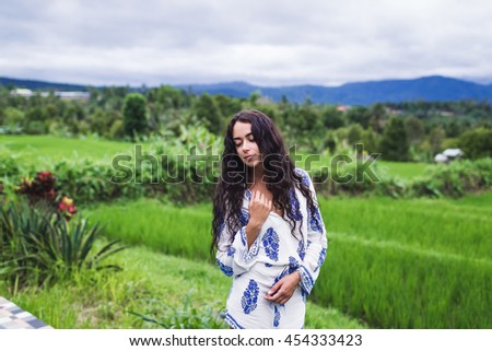 Woman resting in a beautiful hotel in the nature of rice fields in Bali