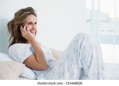 Woman Resting In Bed Talking On The Phone