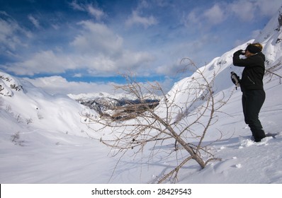 Woman resting and drinking hot tea in high alps in snow