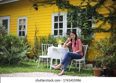 A woman resting on a chair in the garden	
