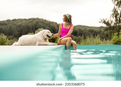 Woman rests with her cute dog near swimming pool, spending summer time together. Concept of friendship with pets and summer vacation - Powered by Shutterstock