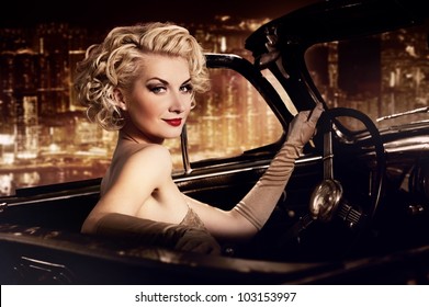 Woman In Retro Car Against Night City.