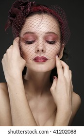 Woman  In Retro-styled Bordeaux Veil With Make-up