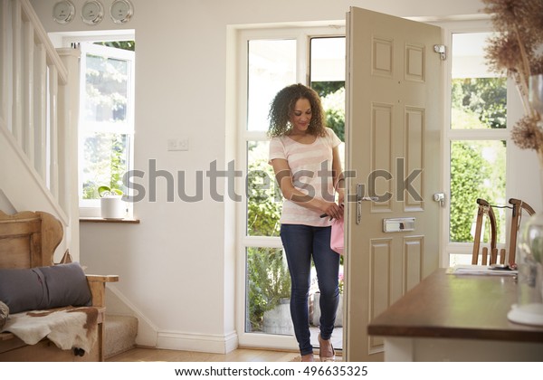 Woman Returning\
Home And Opening Front\
Door