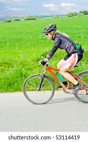 Woman ride mountain bike, motion blur.