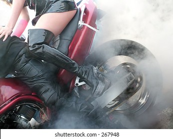 Woman rides as a passenger during a burnout